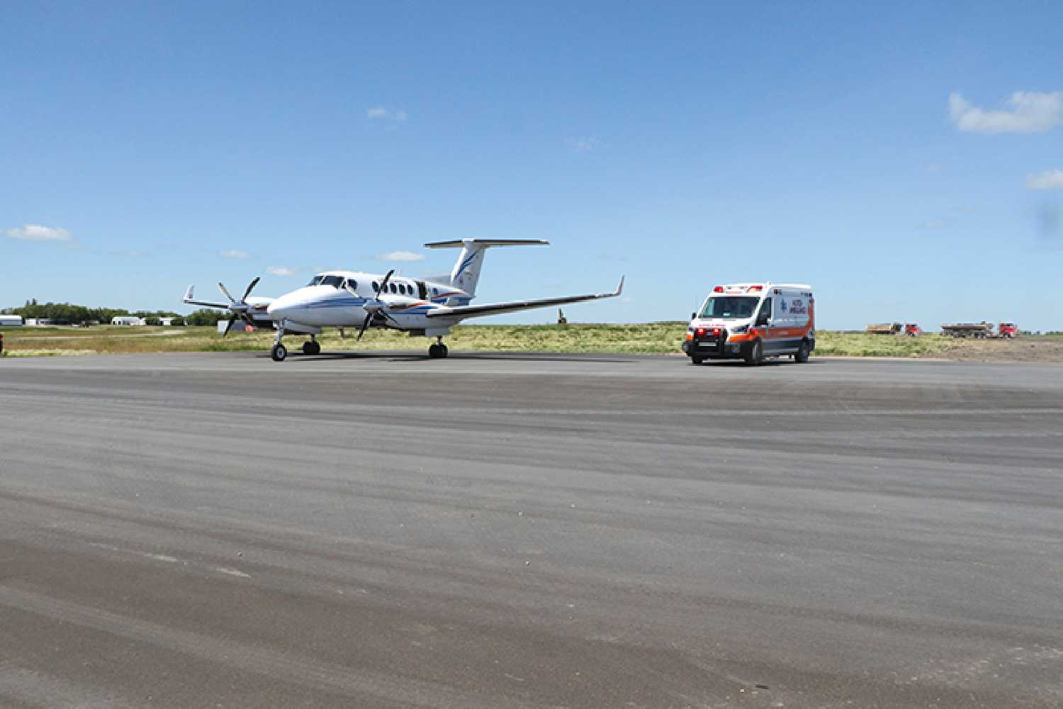 A patient is transfered from ground ambulance to air ambulance at the Moosomin Airport